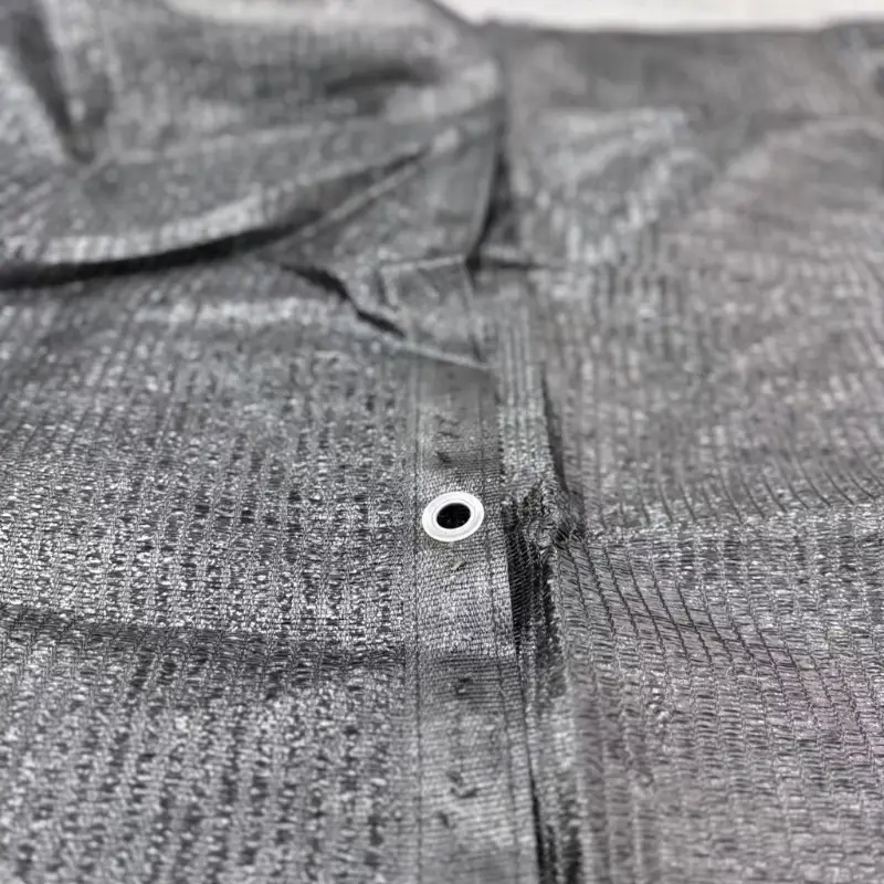 A detailed photo of the stitched, reinforced edge with an aluminum grommet clearly visible, highlighting the durable construction.