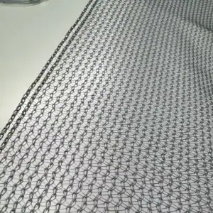 The silver net installed over tomato rows in a commercial greenhouse in Kenya or a similar high-sun region