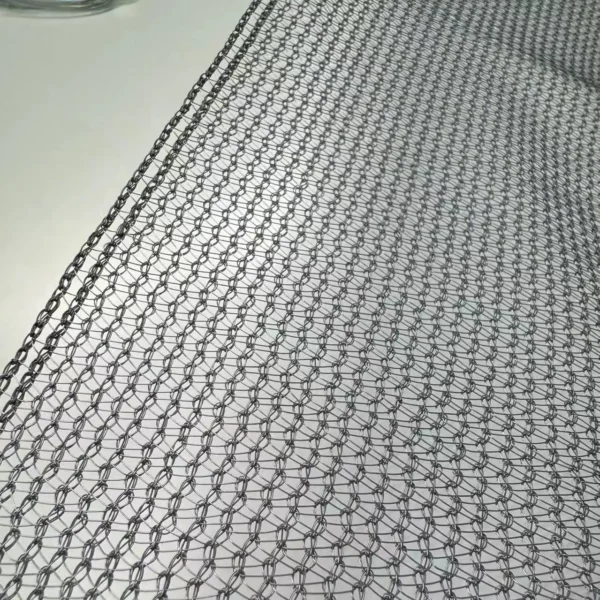 The silver net installed over tomato rows in a commercial greenhouse in Kenya or a similar high-sun region