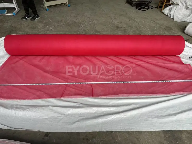 a close up of a finished roll of 30% red shade netting, showing its color and texture.