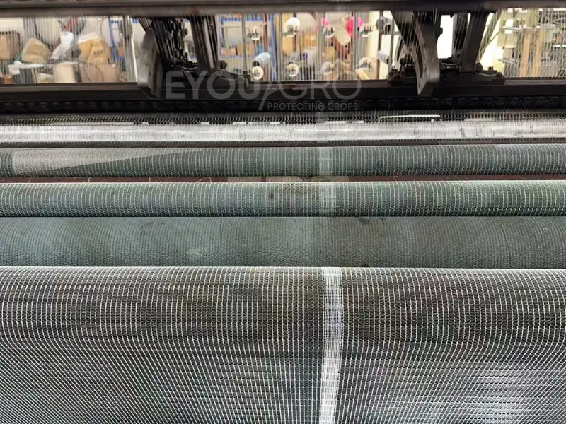 A close-up of the specialized joining process, stitching two net panels together at the EyouAgro factory.