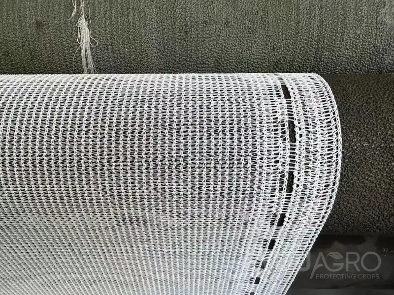 a loom at the eyouagro factory weaving clean, white 50% shade netting.