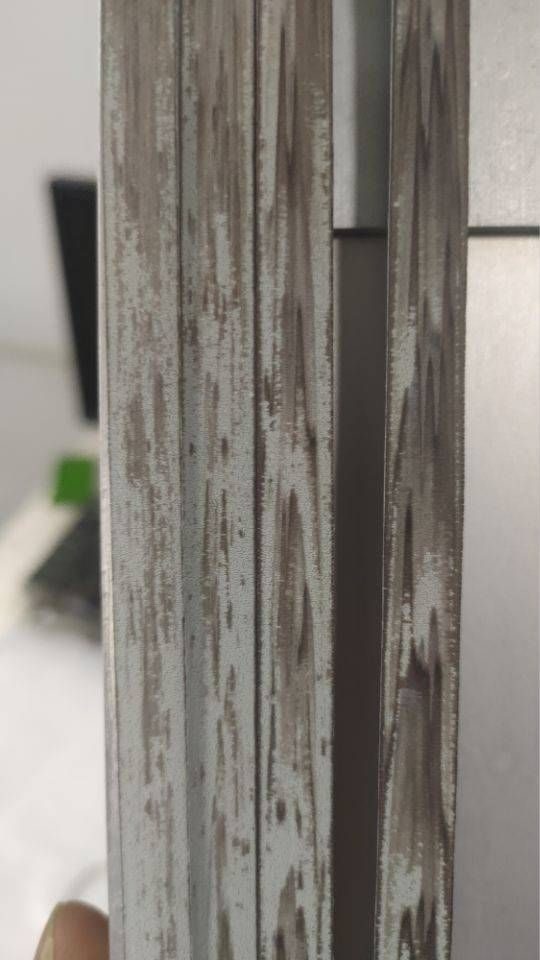 Same PE rattan strip after weathering — faded, chalked and flaking